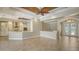 Open-concept living space with tile floors, wood ceiling accents, and a seamless flow into the modern kitchen at 6931 Brier Creek Ct, Lakewood Ranch, FL 34202