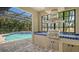 Entertain effortlessly with the outdoor kitchen, complete with a built-in grill and sink, next to the pool at 6931 Brier Creek Ct, Lakewood Ranch, FL 34202