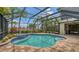 Inviting screened-in pool and hot tub with brick patio and lush landscaping at 6931 Brier Creek Ct, Lakewood Ranch, FL 34202