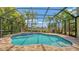 Beautiful pool area with screened enclosure, spa, and lush landscaping for privacy at 6931 Brier Creek Ct, Lakewood Ranch, FL 34202