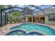 Inviting pool and spa surrounded by lush landscaping and a screened enclosure at 6931 Brier Creek Ct, Lakewood Ranch, FL 34202