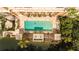 Aerial view of a serene pool area with palm trees and lush surroundings, ideal for relaxation at 750 N Tamiami Trl # 208, Sarasota, FL 34236