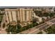 Aerial view of the Renaissance at Rosemary Place building, pond, fountain, pool, and surrounding cityscape at 750 N Tamiami Trl # 208, Sarasota, FL 34236