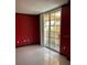 Bedroom with tile floors and balcony access at 750 N Tamiami Trl # 208, Sarasota, FL 34236