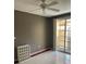 View of empty bedroom with ceiling fan and balcony access at 750 N Tamiami Trl # 208, Sarasota, FL 34236