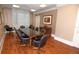 Elegant conference room with a large table, leather chairs, and a wood floor and matching credenza at 750 N Tamiami Trl # 208, Sarasota, FL 34236