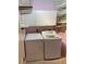 A laundry room features a washer and dryer at 750 N Tamiami Trl # 208, Sarasota, FL 34236