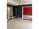 Spacious living room features elegant tiled floors and contrasting wall colors at 750 N Tamiami Trl # 208, Sarasota, FL 34236
