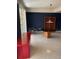 Living room with tiled floors, bookshelf, and balcony access at 750 N Tamiami Trl # 208, Sarasota, FL 34236