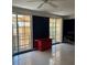 Living room with tiled floors and access to balcony through sliding glass doors at 750 N Tamiami Trl # 208, Sarasota, FL 34236