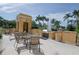 Inviting outdoor seating area with a barbecue, tables, chairs, and a fountain, ideal for gatherings at 750 N Tamiami Trl # 208, Sarasota, FL 34236