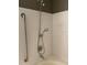 Shower with handheld shower head, safety bar and white tile surround at 750 N Tamiami Trl # 208, Sarasota, FL 34236