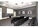 Community theater room with comfortable seating, a large screen, and classic movie posters on the wall at 750 N Tamiami Trl # 208, Sarasota, FL 34236