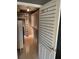 Spacious walk-in closet featuring custom shelving, drawers, and rod space at 750 N Tamiami Trl # 208, Sarasota, FL 34236