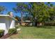 Expansive backyard featuring lush green lawn, privacy fence, and mature shade trees perfect for outdoor activities at 91 39Th Street Nw Ct, Bradenton, FL 34205