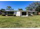 Beautiful backyard with a well-maintained lawn, lush landscaping, and a screened porch at 91 39Th Street Nw Ct, Bradenton, FL 34205