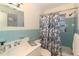 Light and airy bathroom with vanity, patterned shower curtain, and natural light at 91 39Th Street Nw Ct, Bradenton, FL 34205
