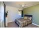 Comfortable bedroom featuring wood-look floors, ceiling fan, and a large window at 91 39Th Street Nw Ct, Bradenton, FL 34205