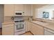 Well-lit kitchen with essential appliances, ample counter space, and classic cabinetry at 91 39Th Street Nw Ct, Bradenton, FL 34205