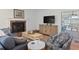 Cozy living room featuring a fireplace, TV, and stylish furniture at 91 39Th Street Nw Ct, Bradenton, FL 34205