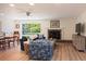 Bright living room with a fireplace, wood floors, and a view to the outdoor area at 91 39Th Street Nw Ct, Bradenton, FL 34205
