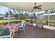 Screened-in porch with a ceiling fan, swing, and outdoor seating for relaxing at 91 39Th Street Nw Ct, Bradenton, FL 34205