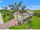 A lovely home with a two-car garage, brick driveway, lush lawn and landscaping, and a tile roof at 9774 Highland Park Pl, Palmetto, FL 34221