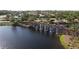 Aerial view of community featuring a beautiful water feature with waterfalls and lush landscaping at 9774 Highland Park Pl, Palmetto, FL 34221