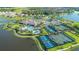 Stunning aerial view of the community with pool, tennis courts, walking path and beautiful landscaping at 9774 Highland Park Pl, Palmetto, FL 34221