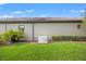 Backyard with lush landscaping and a generator for backup power in case of an outage at 9774 Highland Park Pl, Palmetto, FL 34221