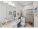 Bathroom features a shower with a glass door, vanity and toilet at 9774 Highland Park Pl, Palmetto, FL 34221