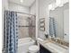 Bathroom with a tub-shower combo, granite counter tops, and a decorative shower curtain at 9774 Highland Park Pl, Palmetto, FL 34221