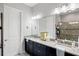 Well-lit bathroom features dual vanities, granite countertops, walk-in shower with glass door at 9774 Highland Park Pl, Palmetto, FL 34221