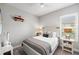 Comfortable bedroom featuring neutral colors, a ceiling fan, and lots of natural light from the window at 9774 Highland Park Pl, Palmetto, FL 34221