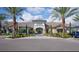 Beautiful clubhouse exterior featuring meticulous landscaping, ample parking and a welcoming entrance at 9774 Highland Park Pl, Palmetto, FL 34221