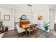Dining area with hardwood floors, an elegant light fixture, and a view of the home's decor at 9774 Highland Park Pl, Palmetto, FL 34221