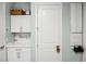 Laundry Room with cabinets above counter and a 