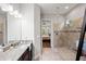 Modern bathroom features dual vanities, granite countertops, walk-in shower and views into the main bedroom at 9774 Highland Park Pl, Palmetto, FL 34221