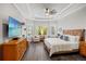 Bright main bedroom features hardwood floors, tray ceiling, large windows and comfortable seating at 9774 Highland Park Pl, Palmetto, FL 34221