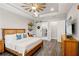 Spacious main bedroom features hardwood floors, tray ceiling, barn door and a large dresser at 9774 Highland Park Pl, Palmetto, FL 34221