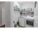Efficient laundry room with modern washer and dryer, ample shelving and storage solutions at 11213 78Th E Ln, Parrish, FL 34219
