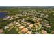 This aerial shot shows the property surrounded by lush landscaping, lakes and a golf course in a lovely community at 11447 Savannah Lakes Dr, Parrish, FL 34219