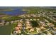 Aerial view shows the property with lush landscaping, surrounded by lakes and golf course in a serene community at 11447 Savannah Lakes Dr, Parrish, FL 34219