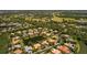 Beautiful aerial view of the property within a serene community setting with golf course, lake and lush greenery at 11447 Savannah Lakes Dr, Parrish, FL 34219