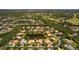Aerial view showcases property within a community featuring a pond and golf course in a beautiful surrounding environment at 11447 Savannah Lakes Dr, Parrish, FL 34219