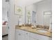Bright bathroom featuring a double vanity with granite countertop and decorative shell accents at 11447 Savannah Lakes Dr, Parrish, FL 34219