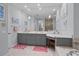 Bathroom features double vanity with grey cabinets, tile flooring and large mirrors at 11447 Savannah Lakes Dr, Parrish, FL 34219