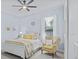 Well-lit bedroom features a plush chair, queen-size bed and a ceiling fan at 11447 Savannah Lakes Dr, Parrish, FL 34219