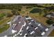Aerial view of community clubhouse, parking area, and golf course, nestled in a scenic area at 11447 Savannah Lakes Dr, Parrish, FL 34219