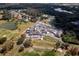 Aerial view showcasing the community clubhouse, golf course and parking area at 11447 Savannah Lakes Dr, Parrish, FL 34219